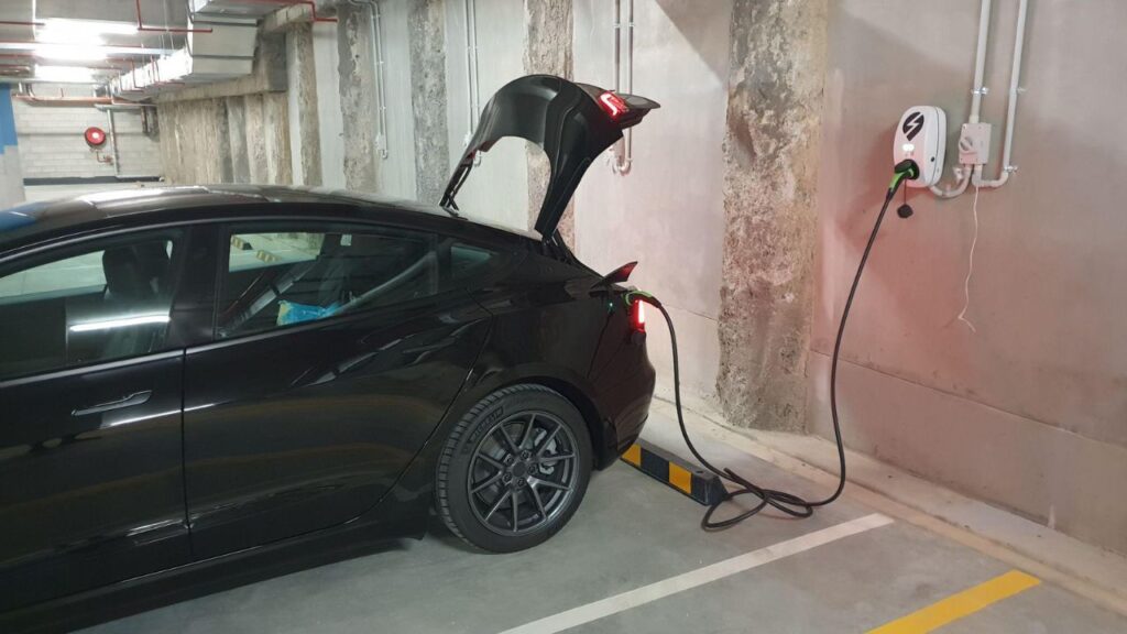 Charging Electric Car Inside The Apartment